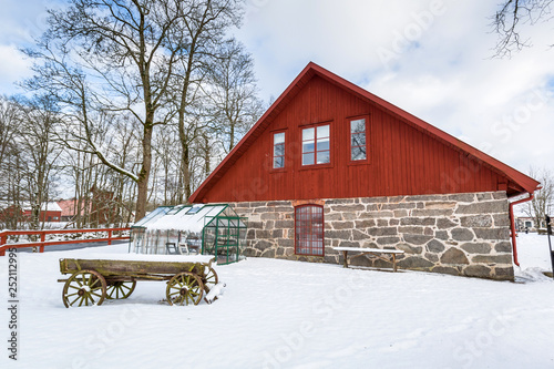 Winter scenery with red wooden house in Sweden © Patryk Kosmider