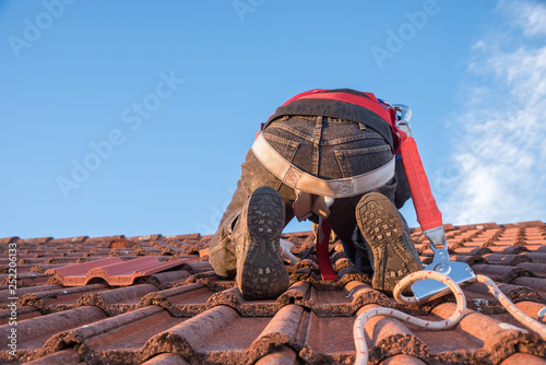 Arbeiter am Dach beim Austausch defekter Dachziegel © SusaZoom