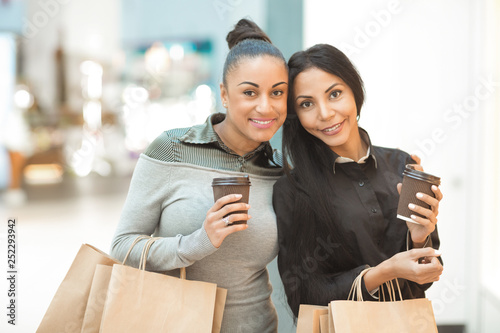 Two African American female friends having coffee and shopping together