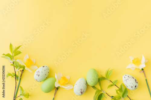 Flat lay easter composition with yellow daffodils and eggs on a yellow background © maria_lh