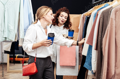 Daughter giving advice for her mother looking for new clothes