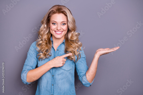 Close up photo amazing beautiful she her lady arm hand palm show hold point empty space offering buy buyer new product wearing casual jeans denim shirt clothes outfit isolated grey background