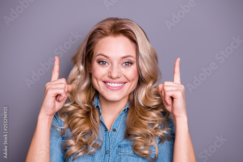 Close up photo amazing beautiful she her lady hold arms hands index fingers point up empty space propose buy buyer new product wearing casual jeans denim shirt clothes outfit isolated grey background