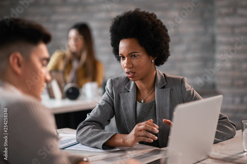 African American financial advisor having a meeting with client in the office.