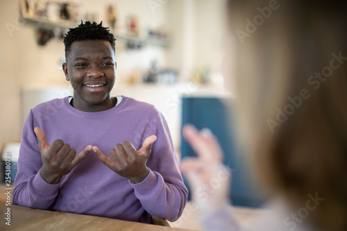 Teenage Boy And Girl Having Conversation Using Sign Language © Daisy Daisy