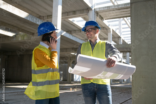Male architect smiling to his colleague female architect