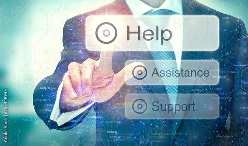 A business man selection a button on a futuristic display with a Help concept written on it.