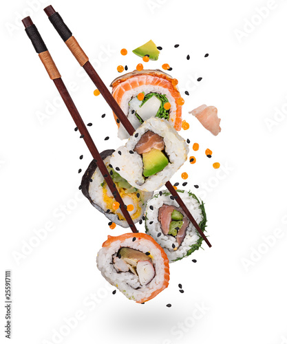 Pieces of delicious japanese sushi frozen in the air. Isolated on white background © Lukas Gojda