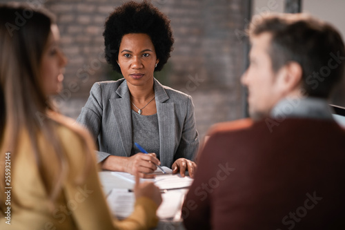 African American financial advisor having a meeting with a couple.