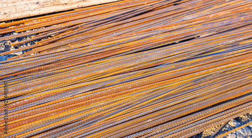 Rusty metal steel reinforcement bars, rods at a construction site © Rawf8