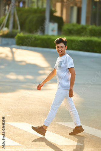 Handsome man walking outdoors © DragonImages