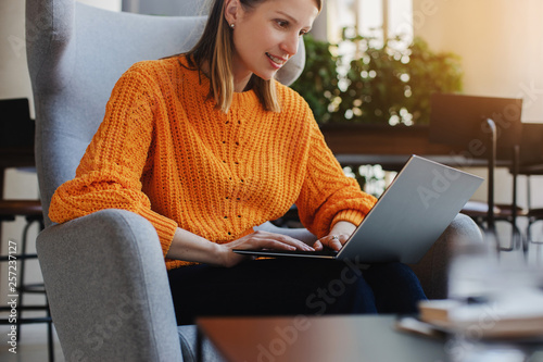 Happy smiling business woman working in modern loft, Beautiful woman using laptop in co-working space © fifeflyingfife