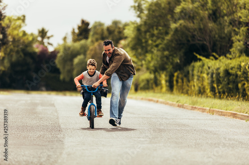 Father teaching his son to ride a bicycle © Jacob Lund 