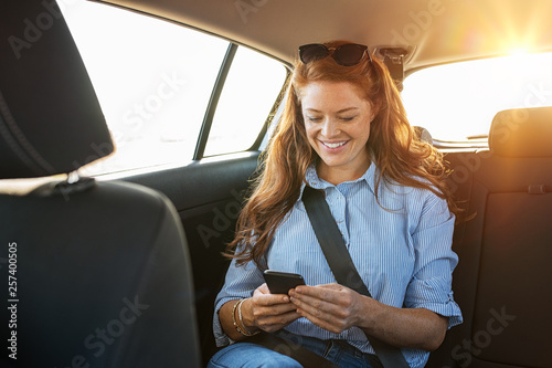 Casual woman using smartphone in car © Rido