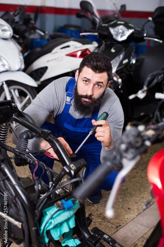 Worker repairing motorbike © JackF