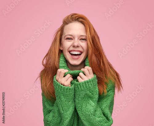 Bright laughing teenage girl on pink background © kegfire