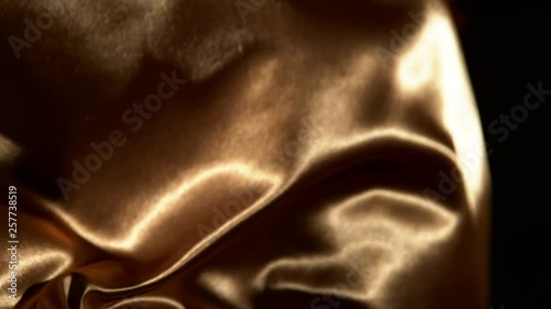 Super slow motion of waving gold velvet cloth in detail. Filmed on high speed cinema camera, 1000fps. © Jag_cz