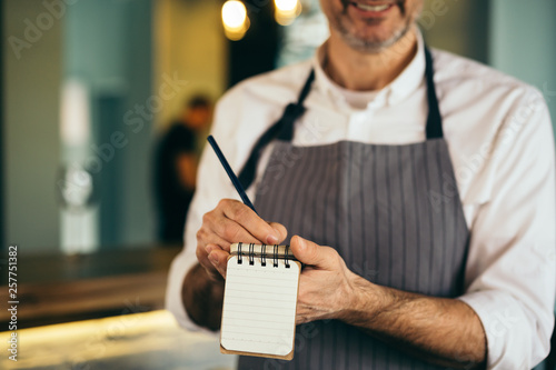 closeup of waiter taking order © cherryandbees