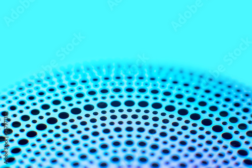 colored metal thing with holes perforated in a circle. Background. selective focus © LariBat