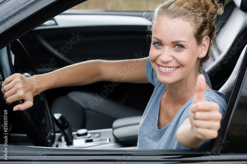 cute woman giving thumb up inside her car © auremar