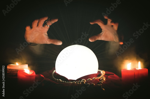 Crystal ball and a fortune teller hands. Future reading concept. © Dmitriy