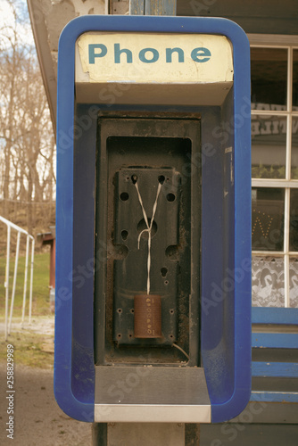 An out-of-service payphone has been equiped with older communication technology