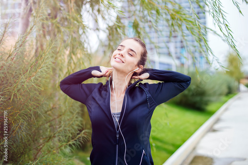 Sporty and active woman runner is listening to music © Boggy