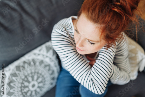 Young redhead woman sitting thinking © contrastwerkstatt