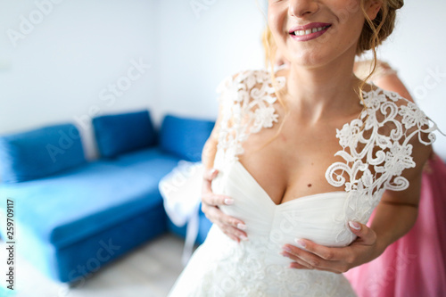 Beautiful blonde bride posing with bouquet of flowers in hands © hreniuca