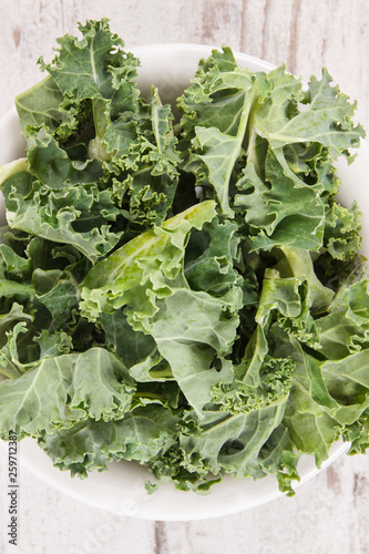 Fresh healthy green curly kale, diet, slimming and healthy eating concept © ratmaner