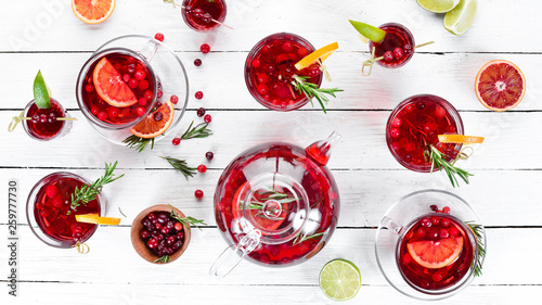 Cranberry juice and beverages. Cranberries, limes, rosemary. On a white background. Top view. Free space for your text. © Yaruniv-Studio