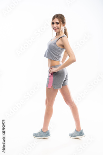 Young sporty Caucasian female model isolated on white background in full body © opolja