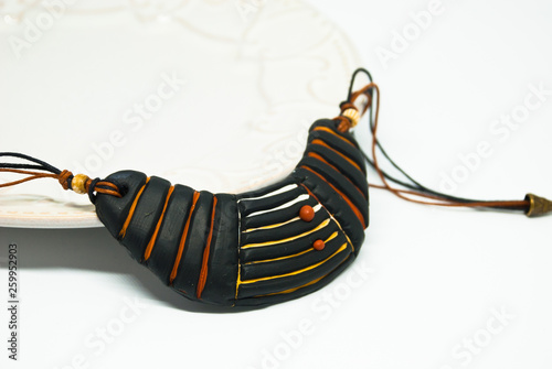 Isolated handmade ethnic bib necklace polymer clay. Black tribal jewelry.
