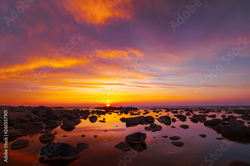 Beautiful sunset at sea side with stones © Anton Gvozdikov