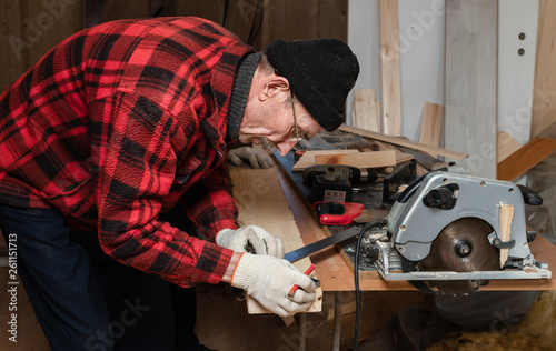 Senior man works as a carpenter in his workshop. Active old age © sonate