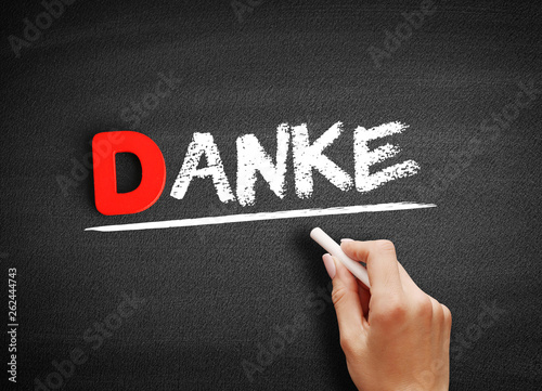 Danke (thank you in german) text on blackboard, concept background © dizain
