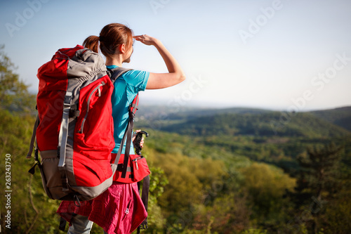 Teenage female hiker watching in distance © luckybusiness