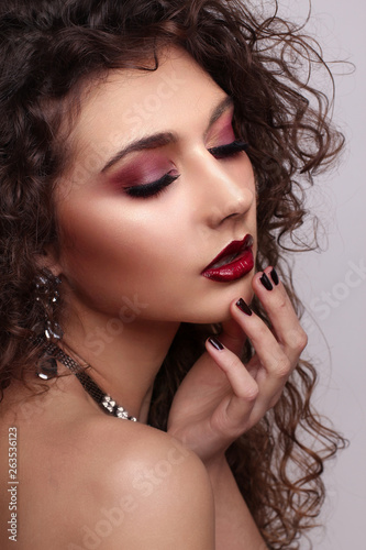 Sexy curly Beauty Girl with purple Lips. Provocative Make up. Luxury Woman with blue Eyes. Fashion. Gorgeous Woman Face. Long curly Hair. © Valeriia