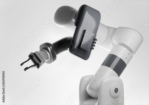 A modern looking programmable robotic arm for use in automatic manufacturing production. Generic robot 3D illustration. © James Thew