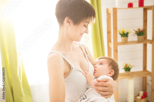 Mother breast feeding her little boy. Mom nursing and feeding baby. Close-up portrait of infant © Alik Mulikov